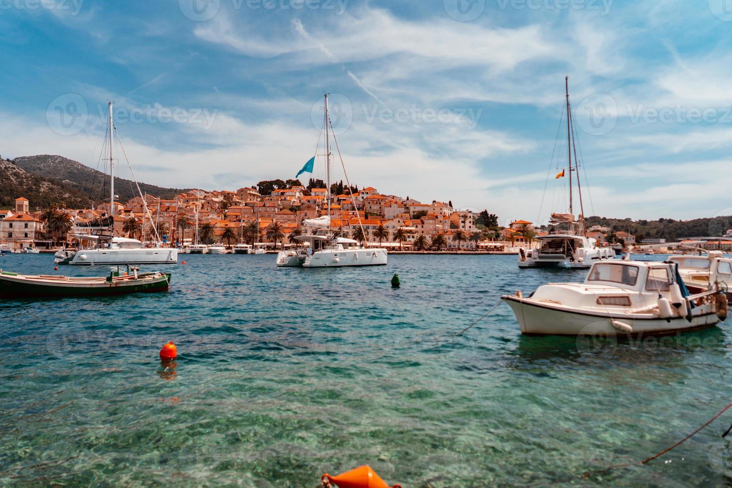 Moored yachts stand in the port town photo