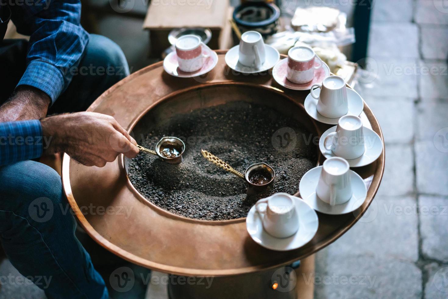 A man make Turkish coffee photo