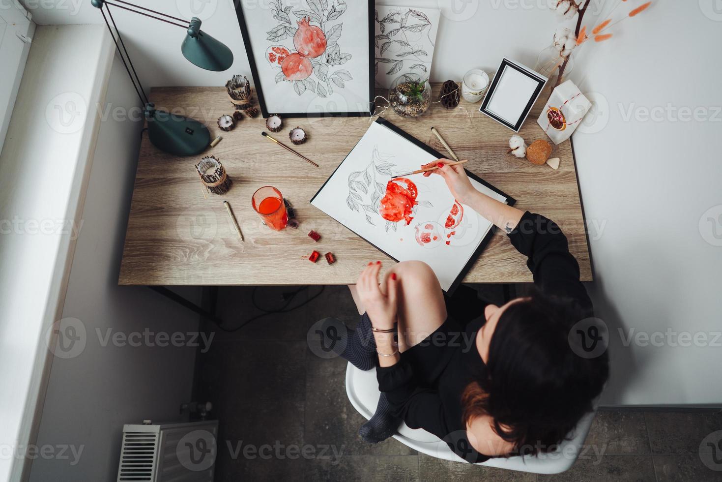 Young woman painting with watercolor paints photo