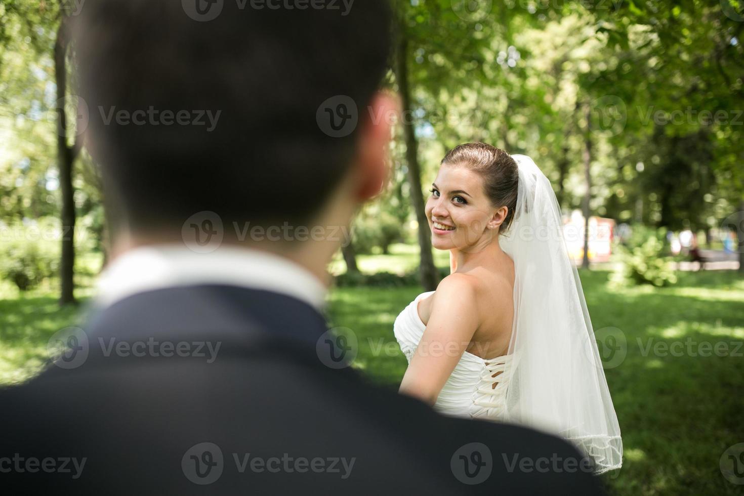 Wedding couple walking in the park photo