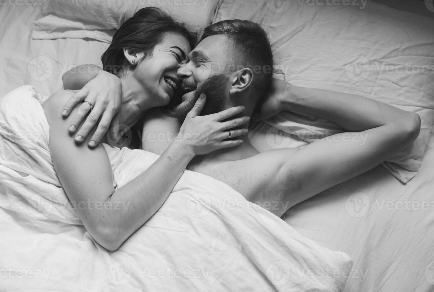 Young couple in bed together photo