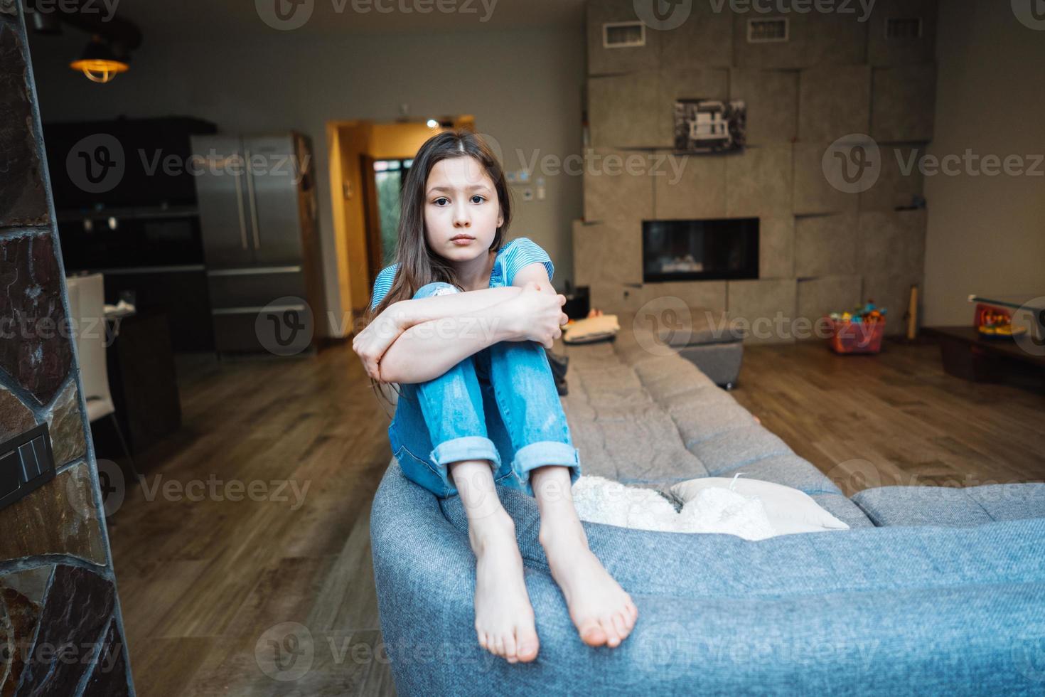 Positive smiling teenage girl on a couch. photo