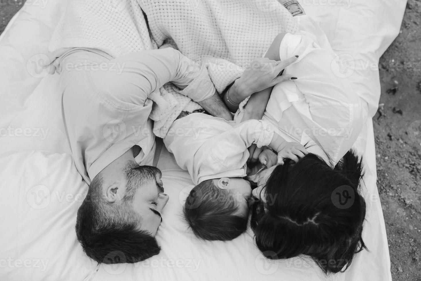 Happy family relaxing together on the mattress photo