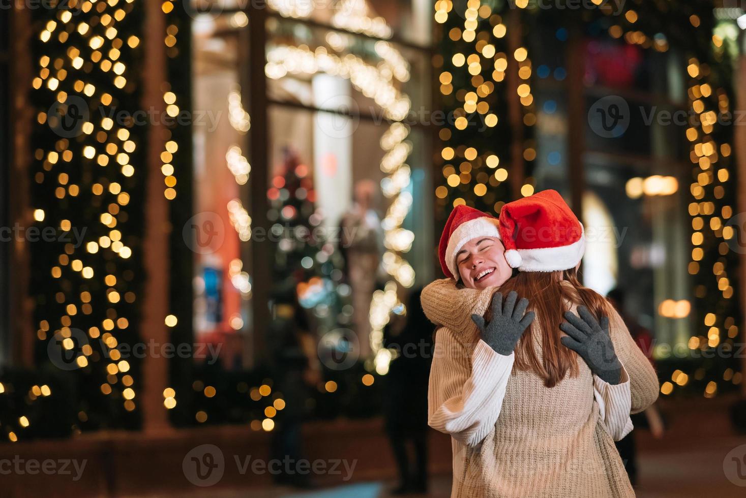 Portrait of happy cute young friends hugging each other photo