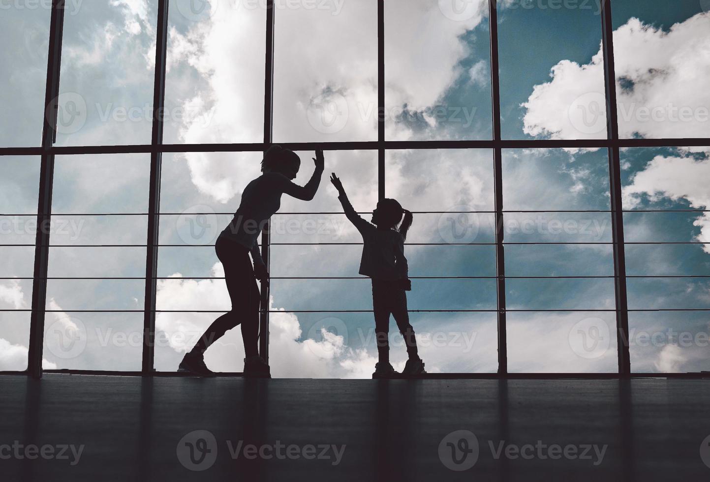 Silhouette of mother and daughter in the gym photo