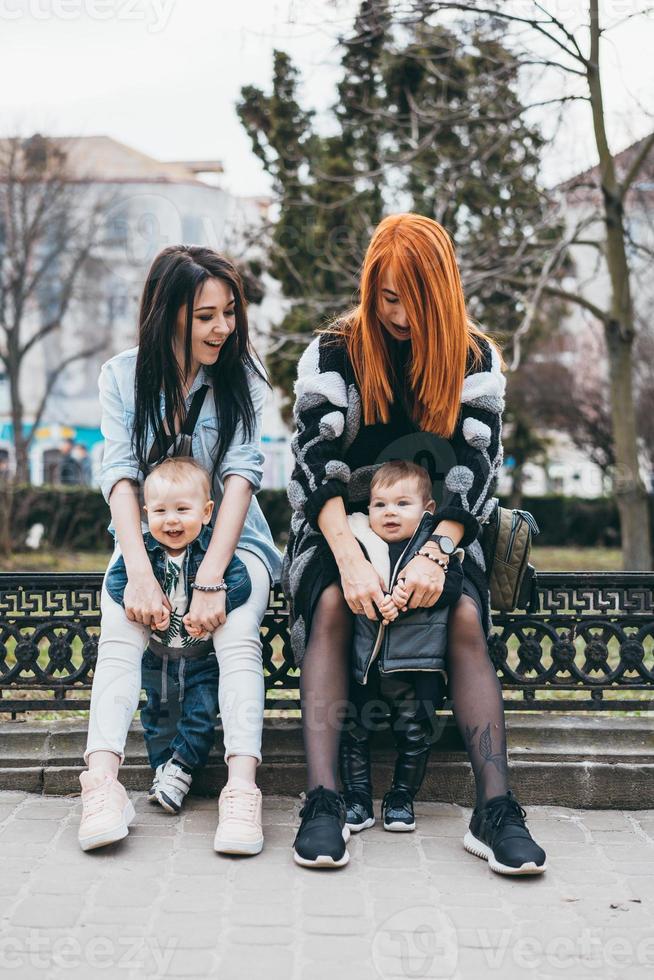 Two moms and their two boys posing on camera photo