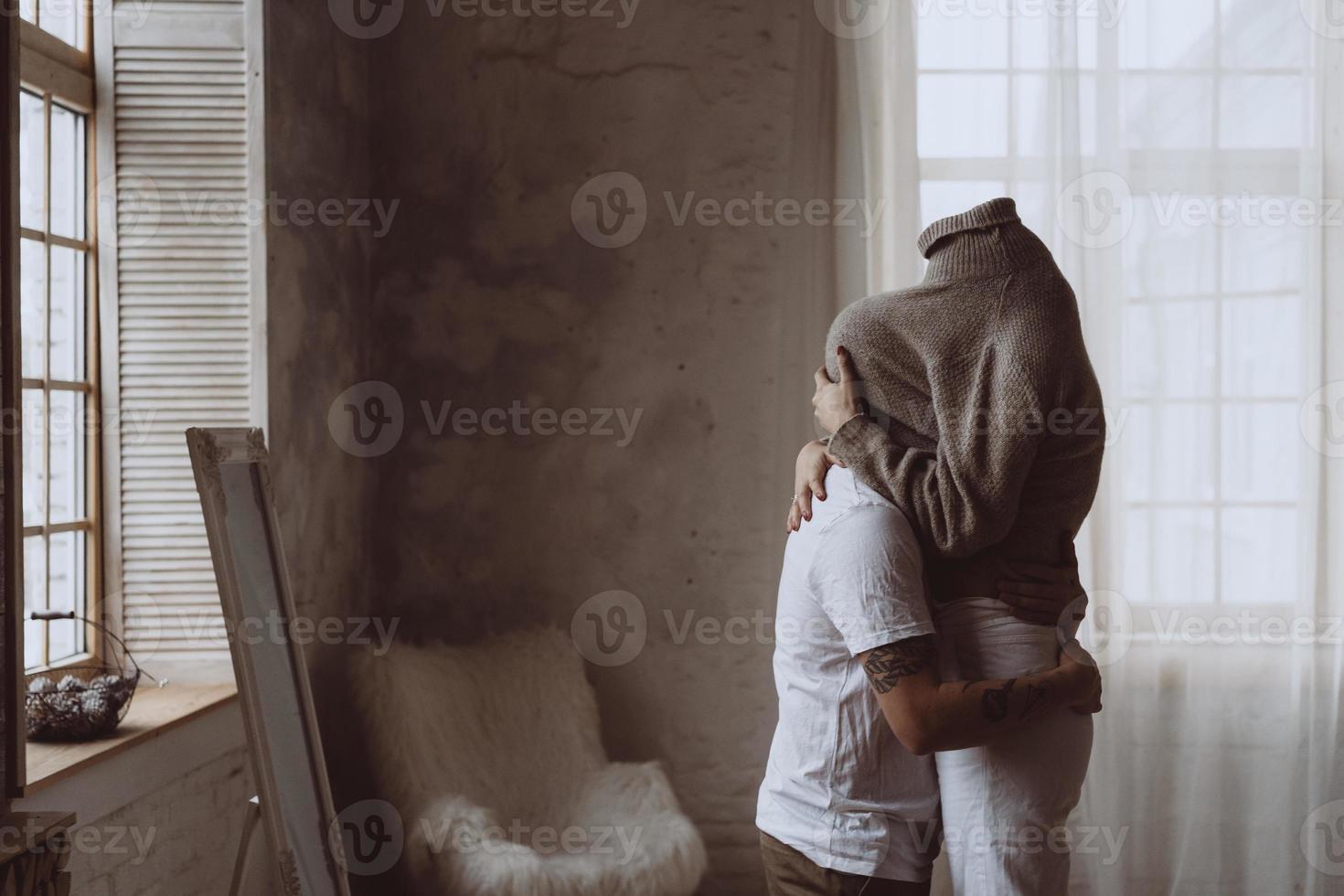 The guy and the girl in each other's arms in the room photo