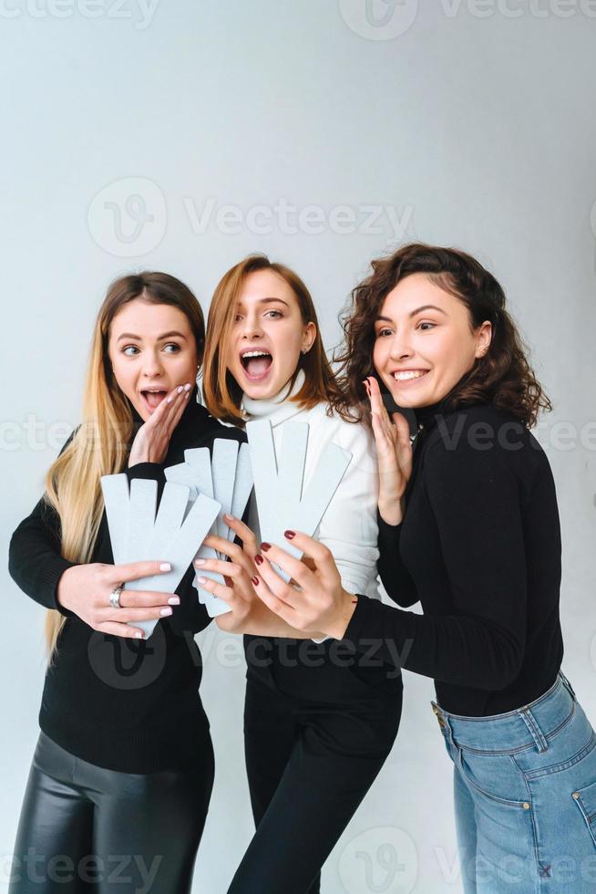 Three beautiful young girls posing for the camera photo