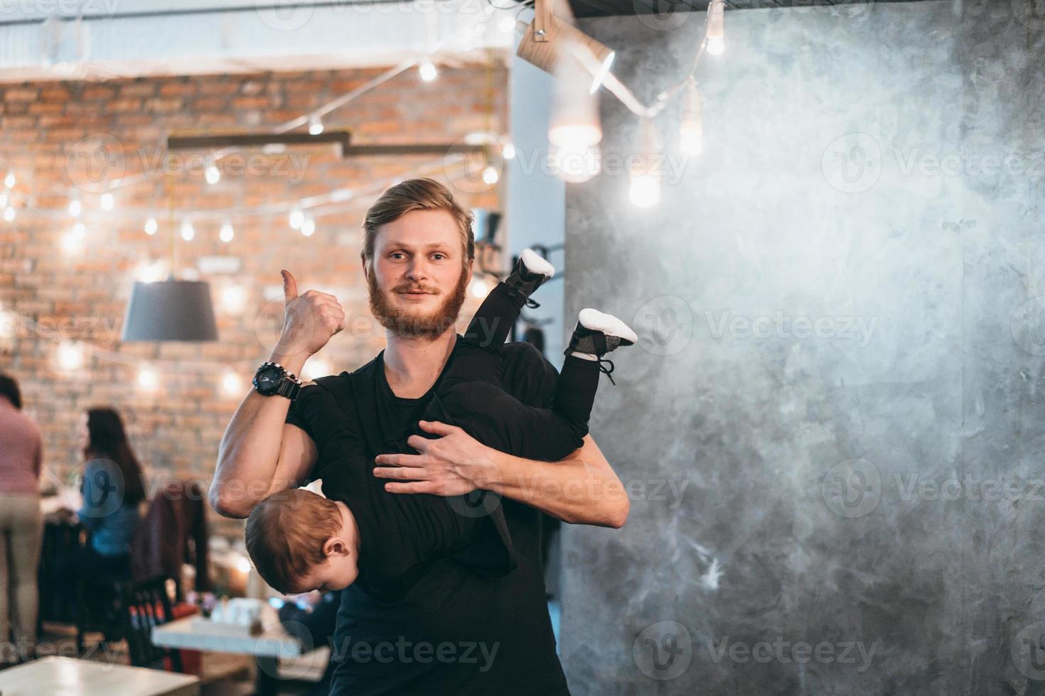 Dad is holding his little son in his arms photo