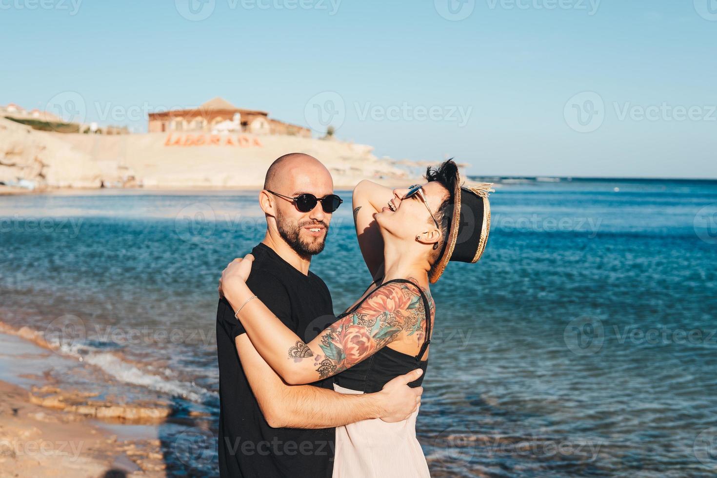 Couple in love embracing each other on beach photo