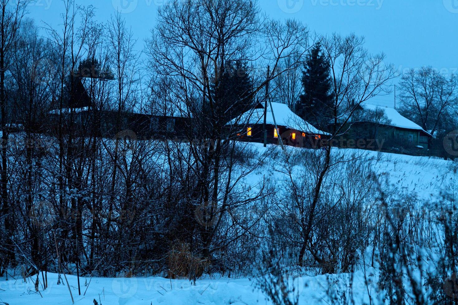 snowed village in blue winter evening photo