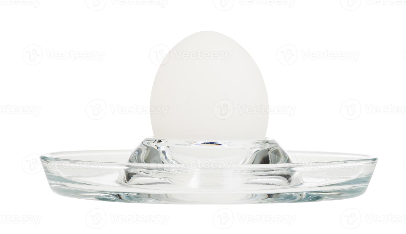 side view of boiled egg in glass egg cup isolated photo