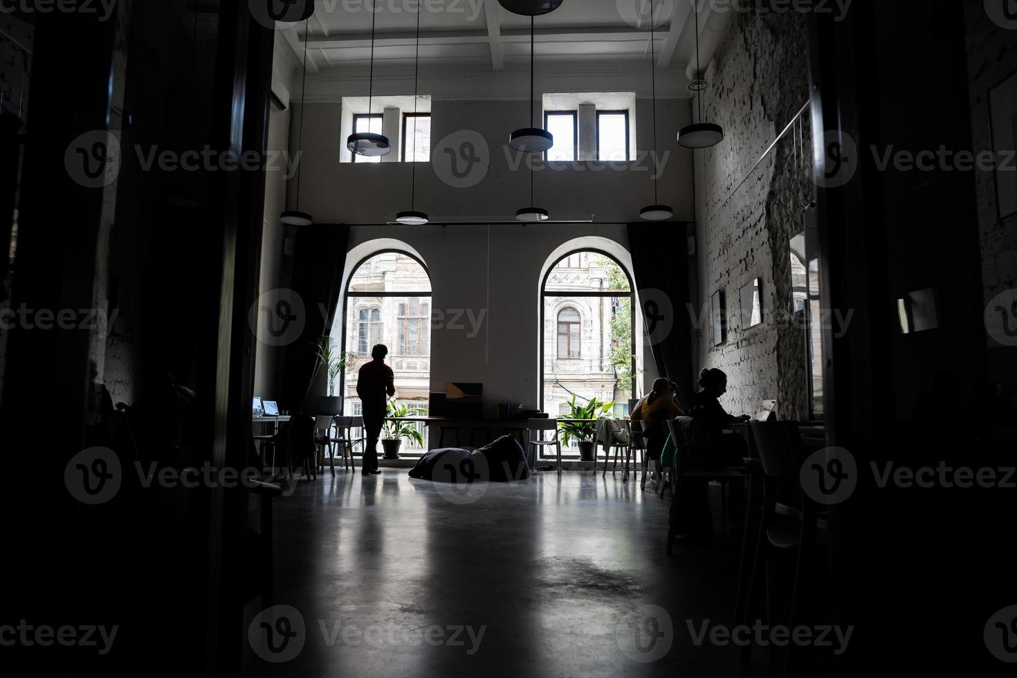 Silhouettes of several colleagues communicating in office photo