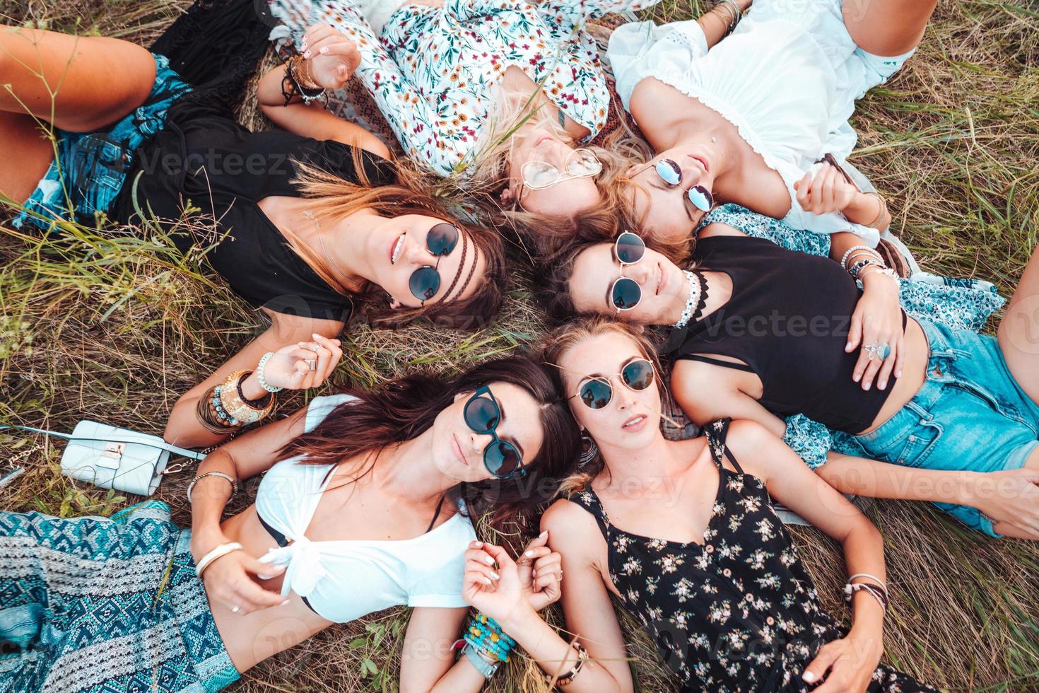 Six girls lie on the grass photo