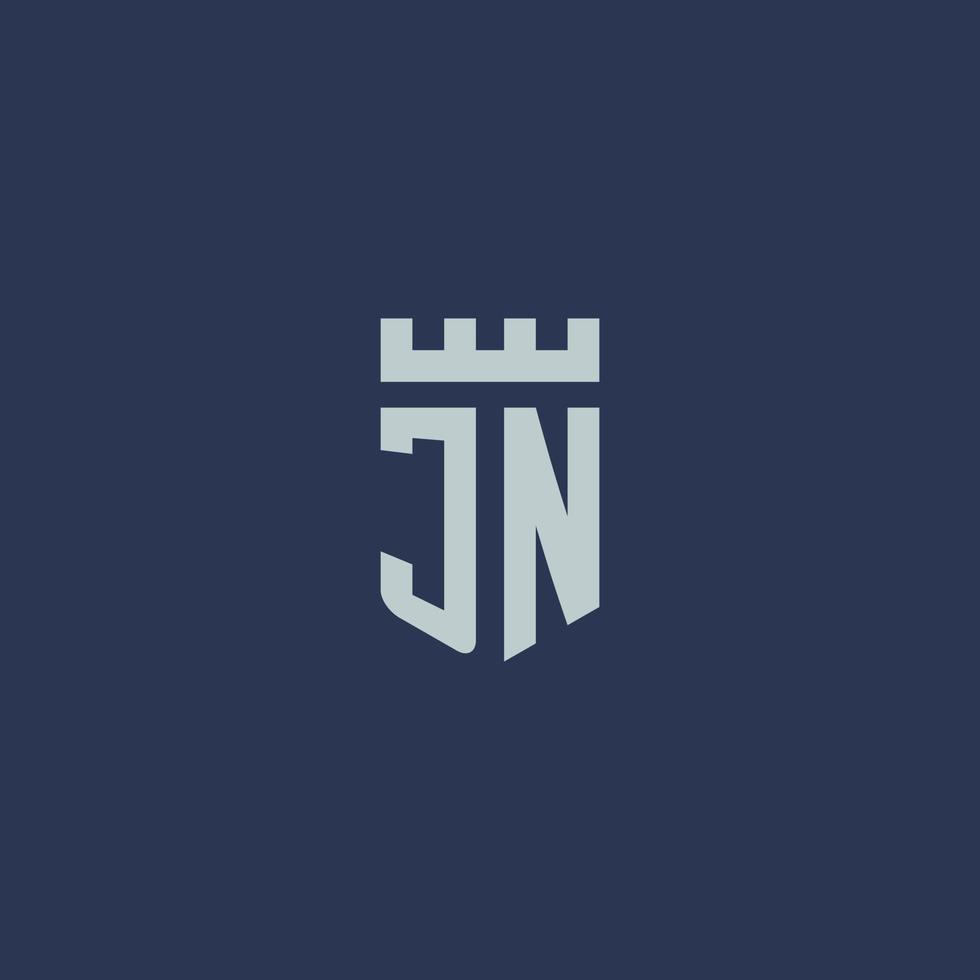 monograma del logotipo jn con castillo de fortaleza y diseño de estilo escudo vector