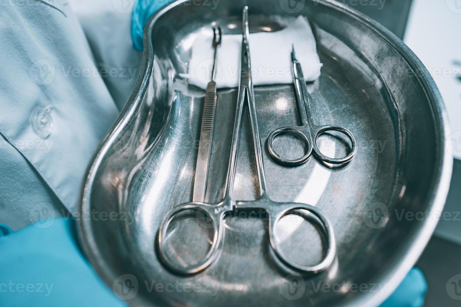 Several surgical instruments lie on a tray photo