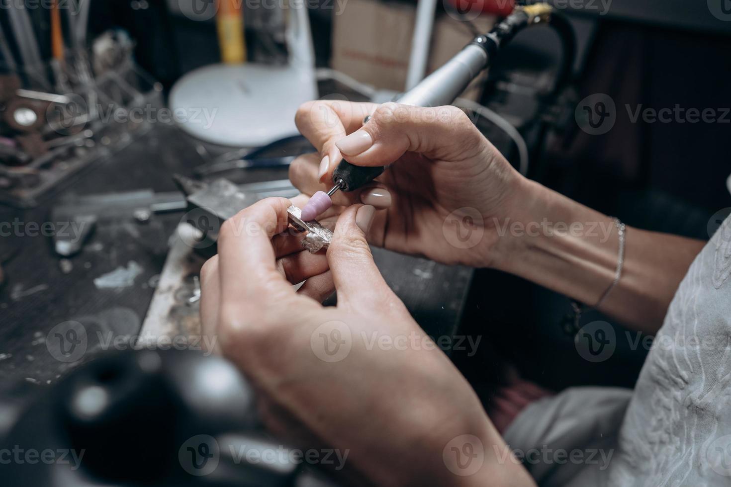 The master processes the valuable metal in the home workshop photo