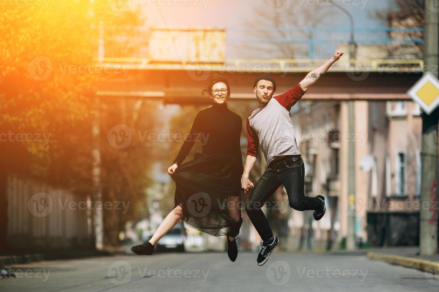 Beautiful young couple jumping photo