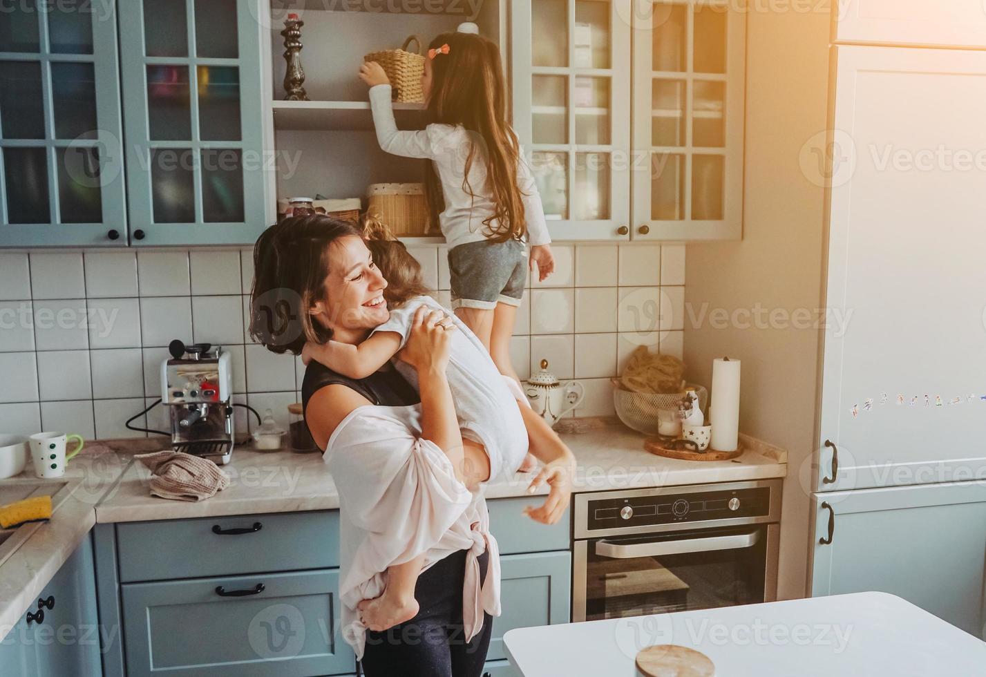 Happy family having fun in the kitchen photo