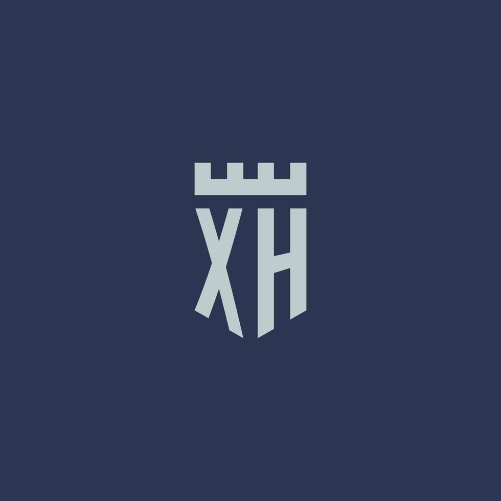 monograma del logotipo xh con castillo de fortaleza y diseño de estilo escudo vector