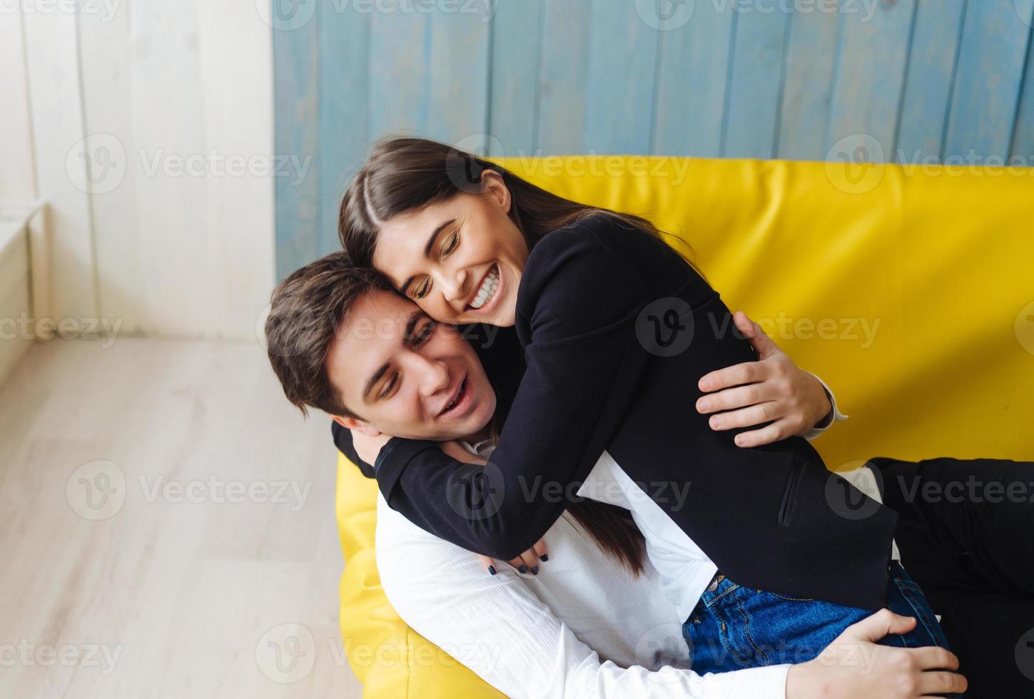 guy and girl on a yellow couch photo