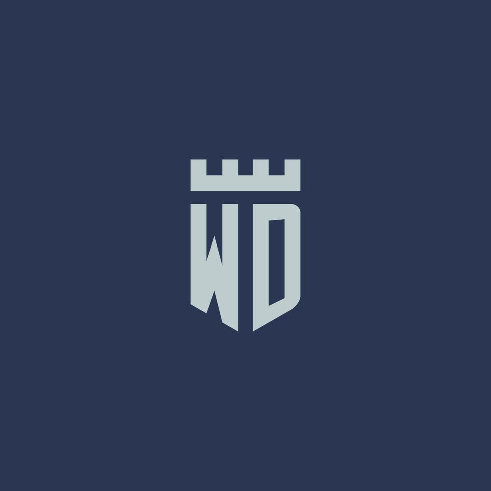 monograma del logotipo de wd con castillo de fortaleza y diseño de estilo de escudo vector