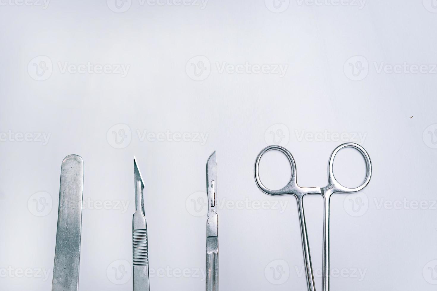 Scapula for throat, two scalpels and clamp on a light background photo