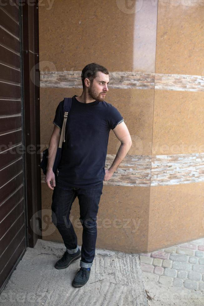 The man in the authentic boots and selvedge jeans  on a background of old city photo