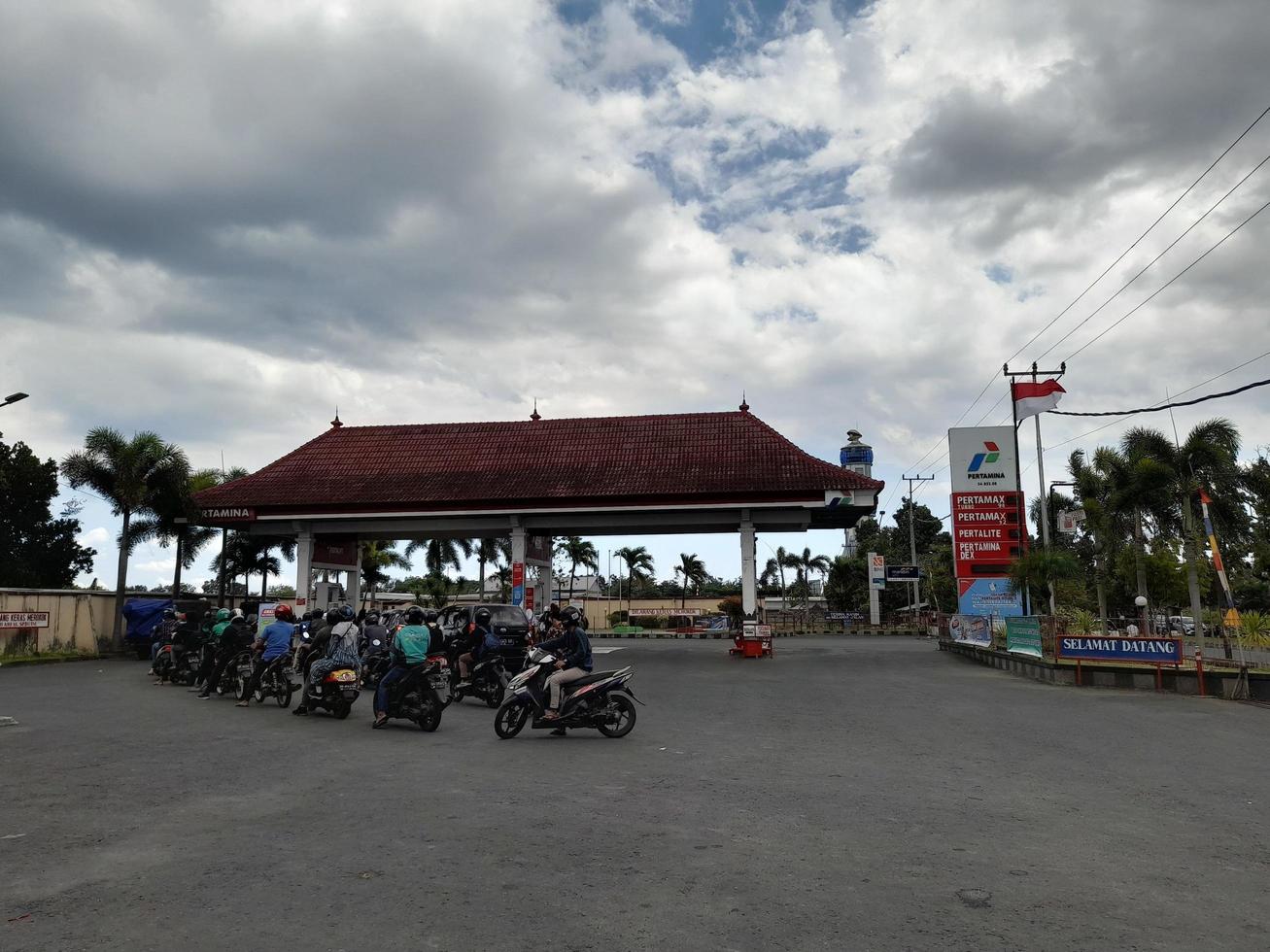 Mataram City, Lombok Island, Indonesia, September 4, 2022, Queue for refueling vehicles at Pertamina's gas station, with cloudy weather photo