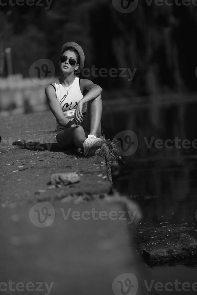 beautiful girl sitting on the pier photo