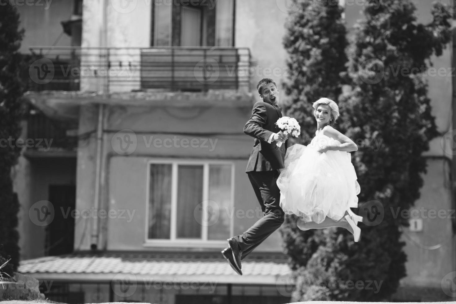 couple jumping on the street photo