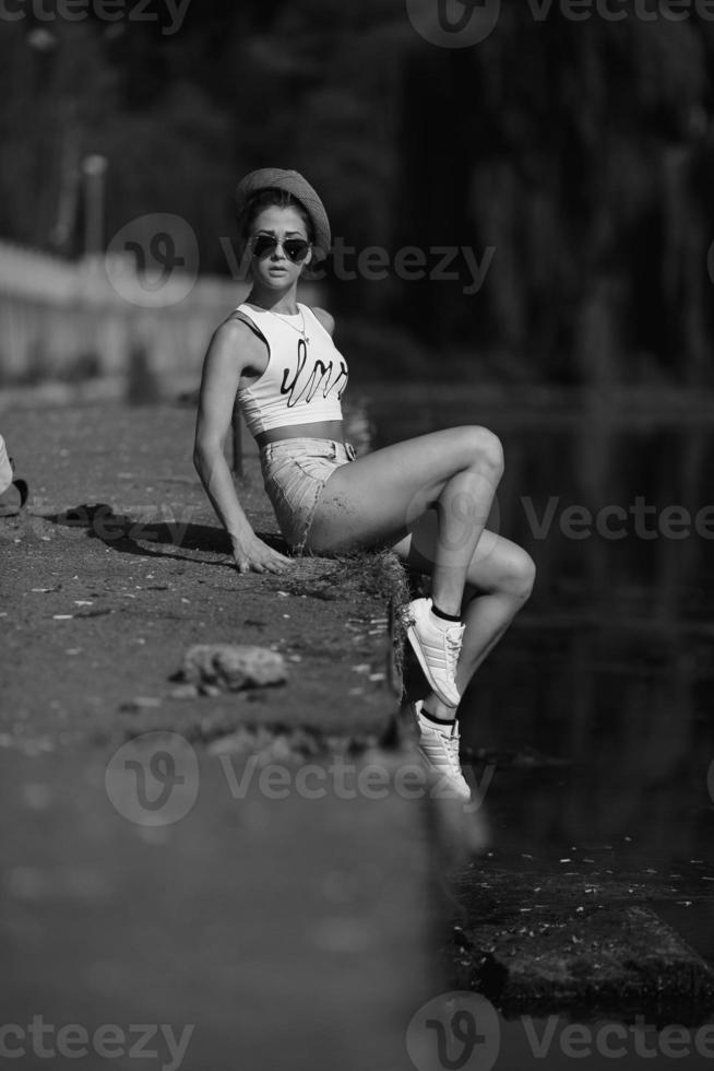 beautiful girl sitting on the pier photo