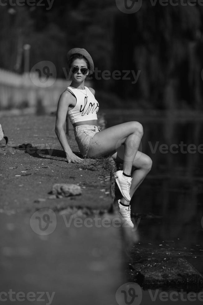 beautiful girl sitting on the pier photo