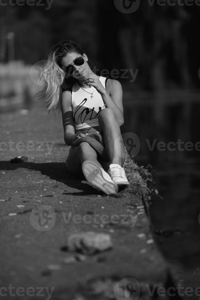 beautiful girl sitting on the pier photo