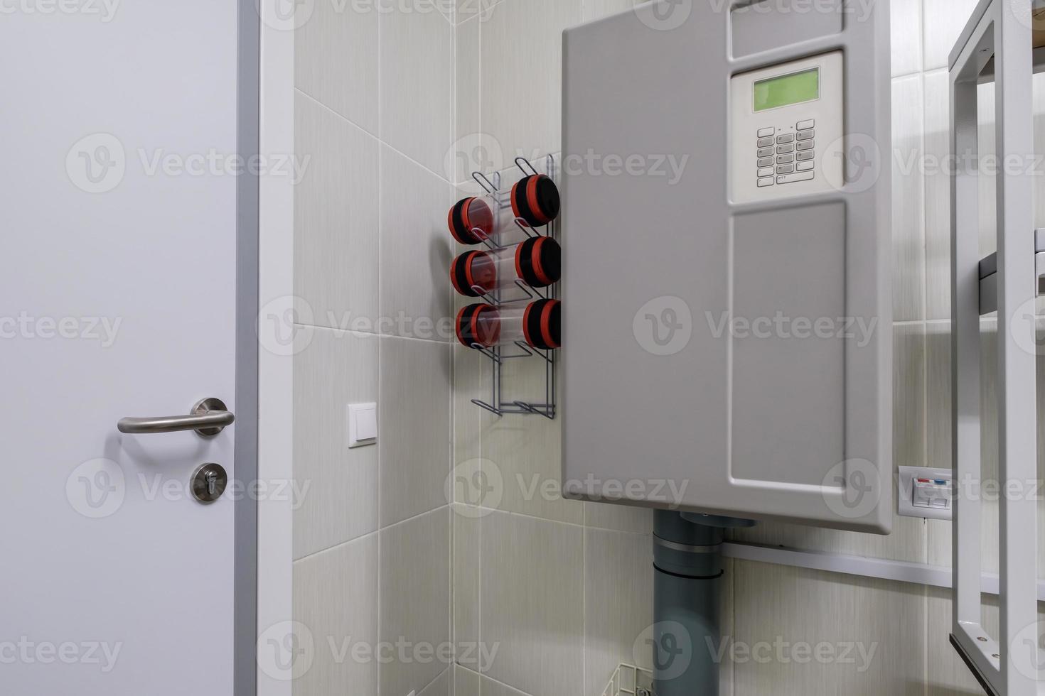 rows of empty pneumatic tubes of transfer system station in modern clinic, designed for fast operational transfer of analyzes, drugs and documents through air tunnels photo