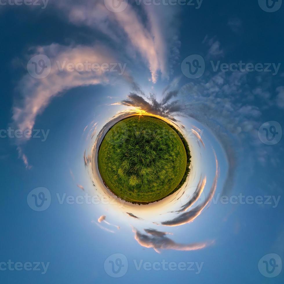 tiny planet in blue sky with beautiful clouds. Transformation of spherical panorama 360 degrees. Spherical abstract aerial view. Curvature of space. photo
