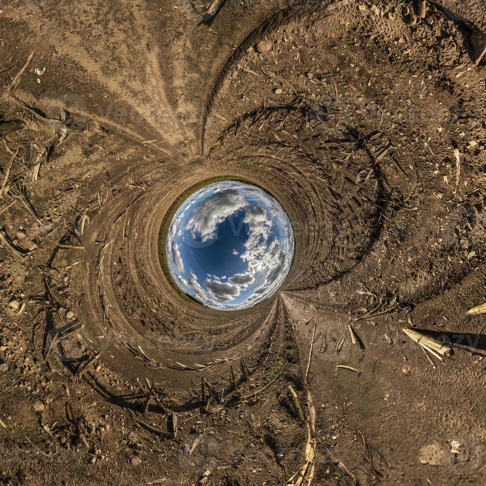 blue sphere little planet inside yellow sand gravel round frame background. photo