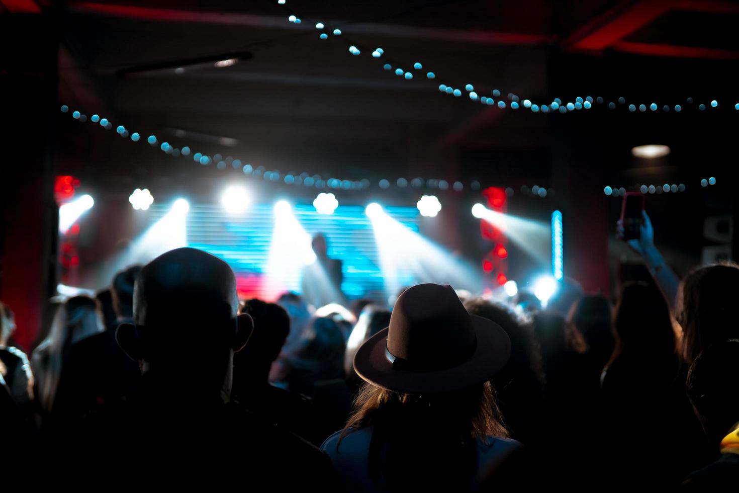 Photo of many people enjoying rock concert in nightclub