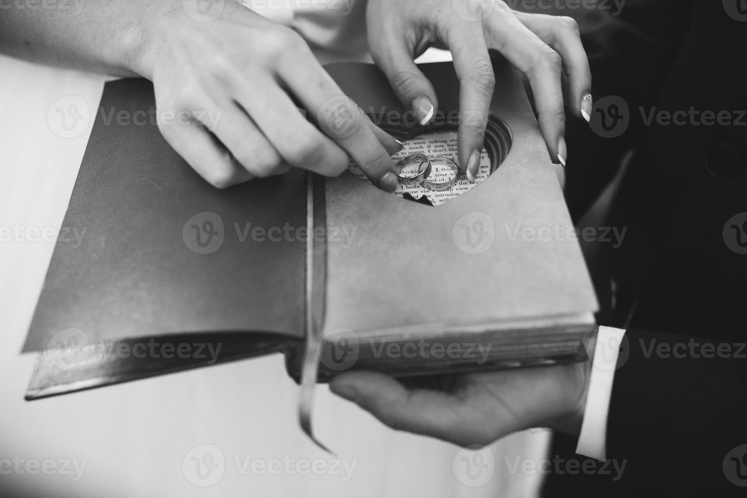 Charming vintage book with handmade heart in which lie the ring. photo