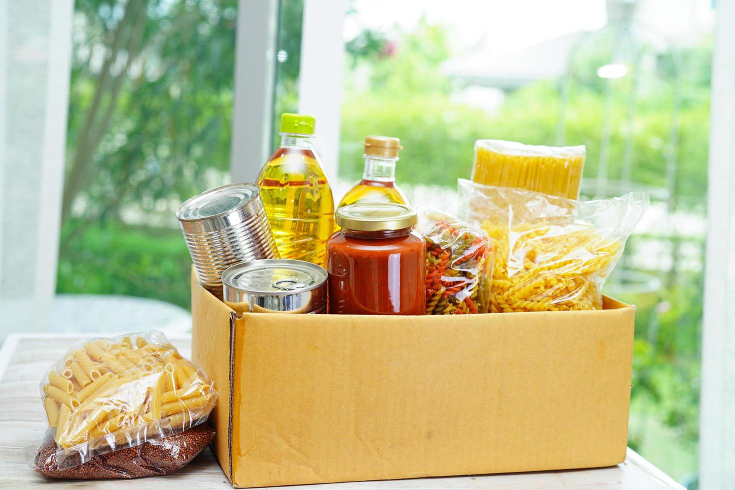 Foodstuffs in donation box for volunteer. photo