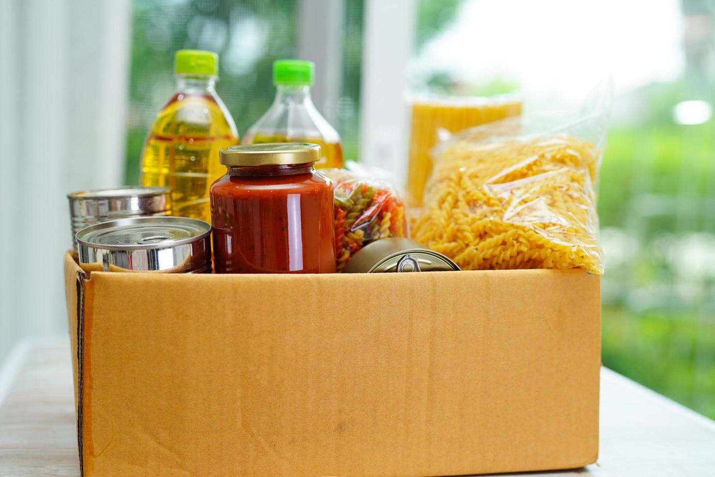 Foodstuffs in donation box for volunteer. photo