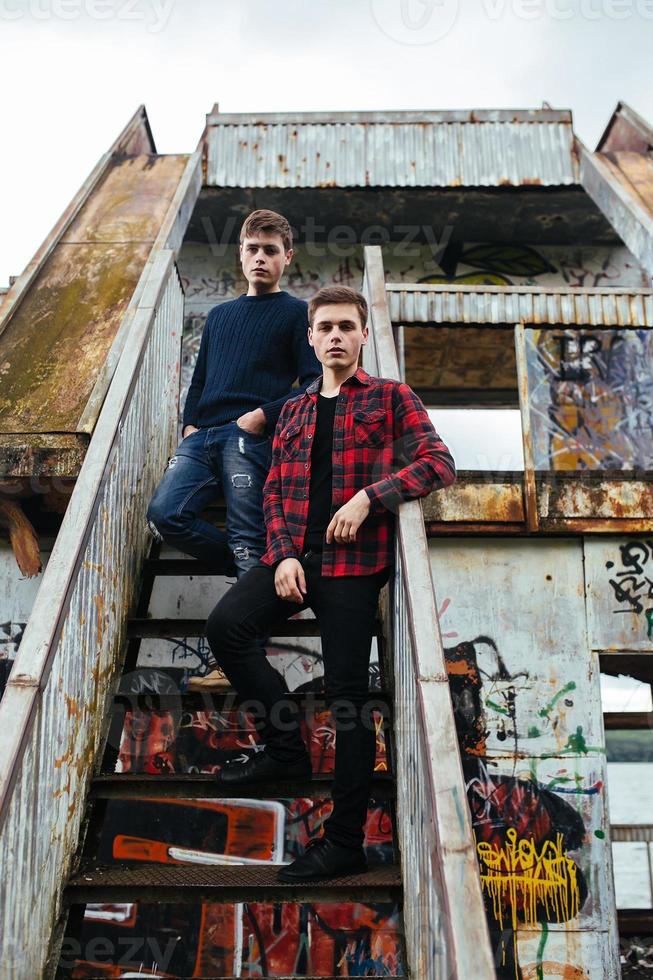 two guys stand in an abandoned building photo