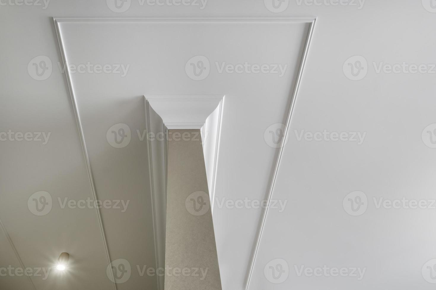 corner of ceiling cornice with intricate crown molding. photo