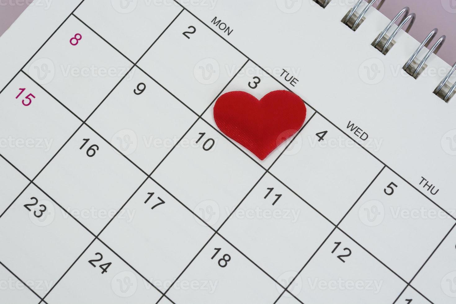 Red heart shape on the date of the 3rd day in the calendar. photo