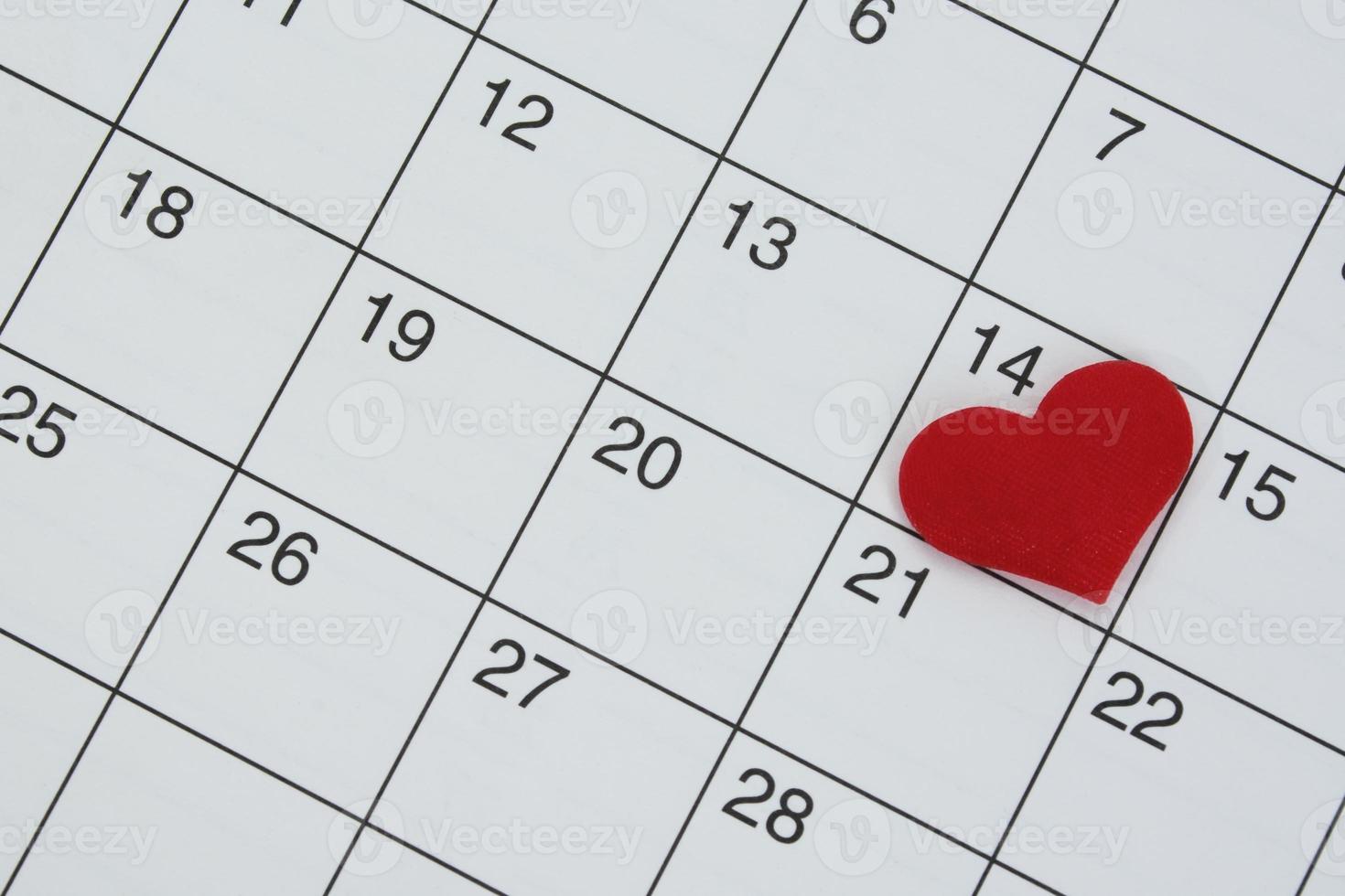 forma de corazón rojo en la fecha del día 14 en el calendario. foto