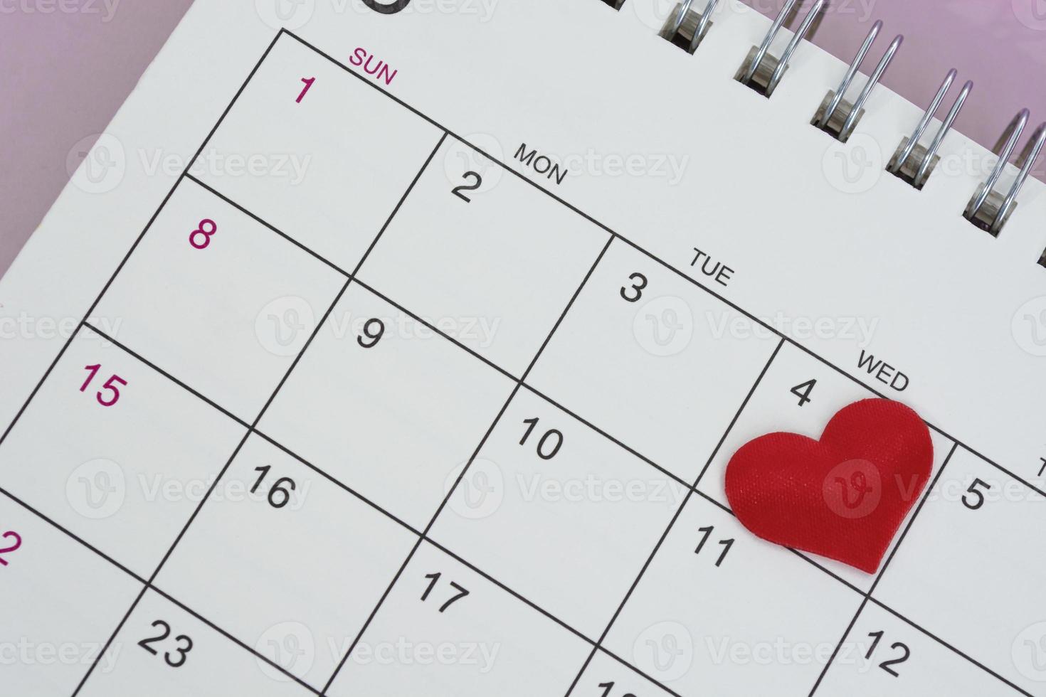 Red heart shape on the date of the 4th day in the calendar. photo