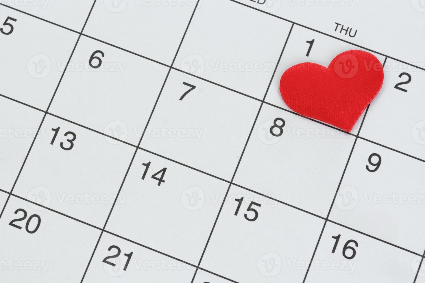 forma de corazón rojo en la fecha del primer día del calendario. foto