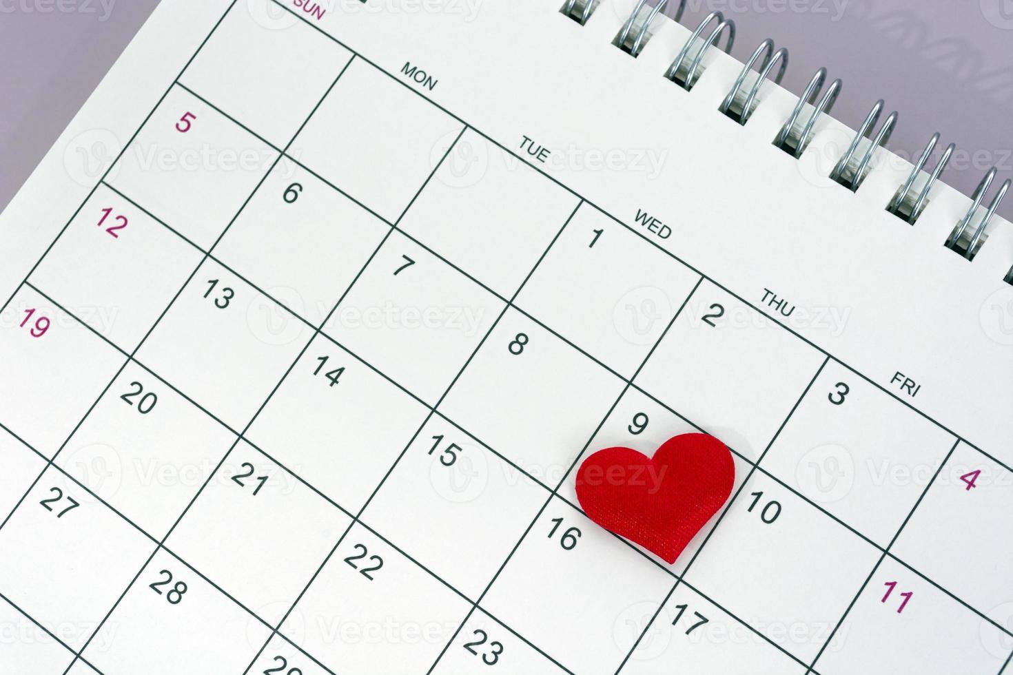 Red heart shape on the date of the 9th day in the calendar. photo