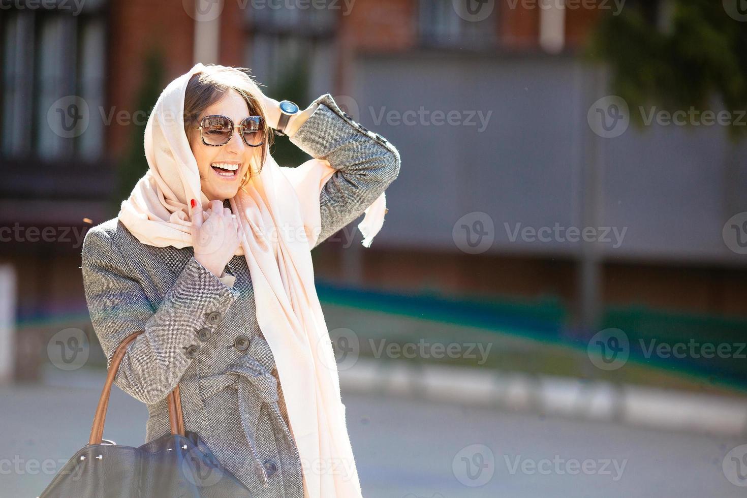 girl in a coat on the street photo
