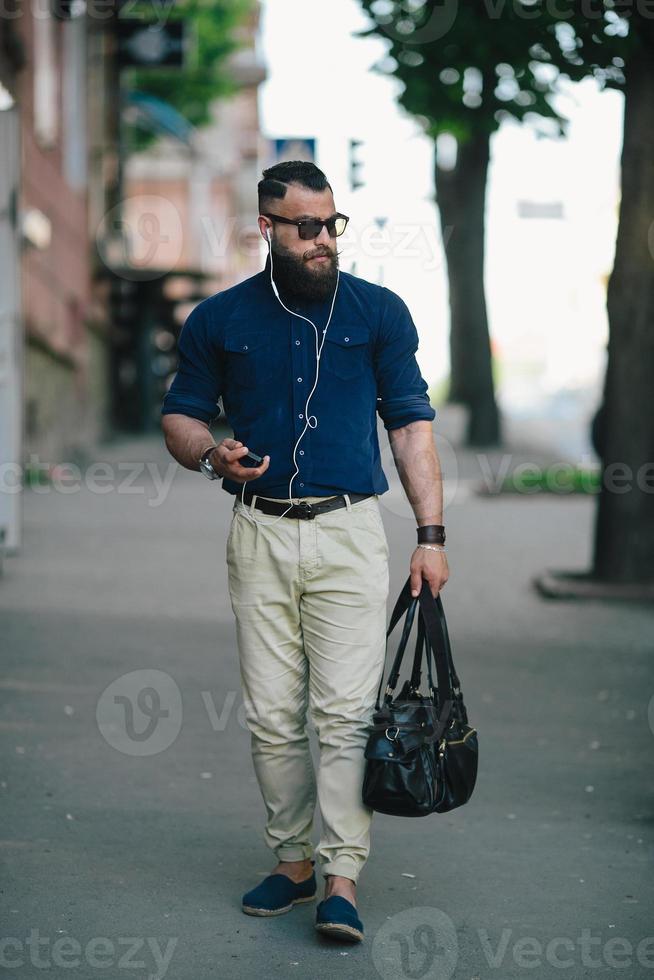 bearded man goes and listens to music photo